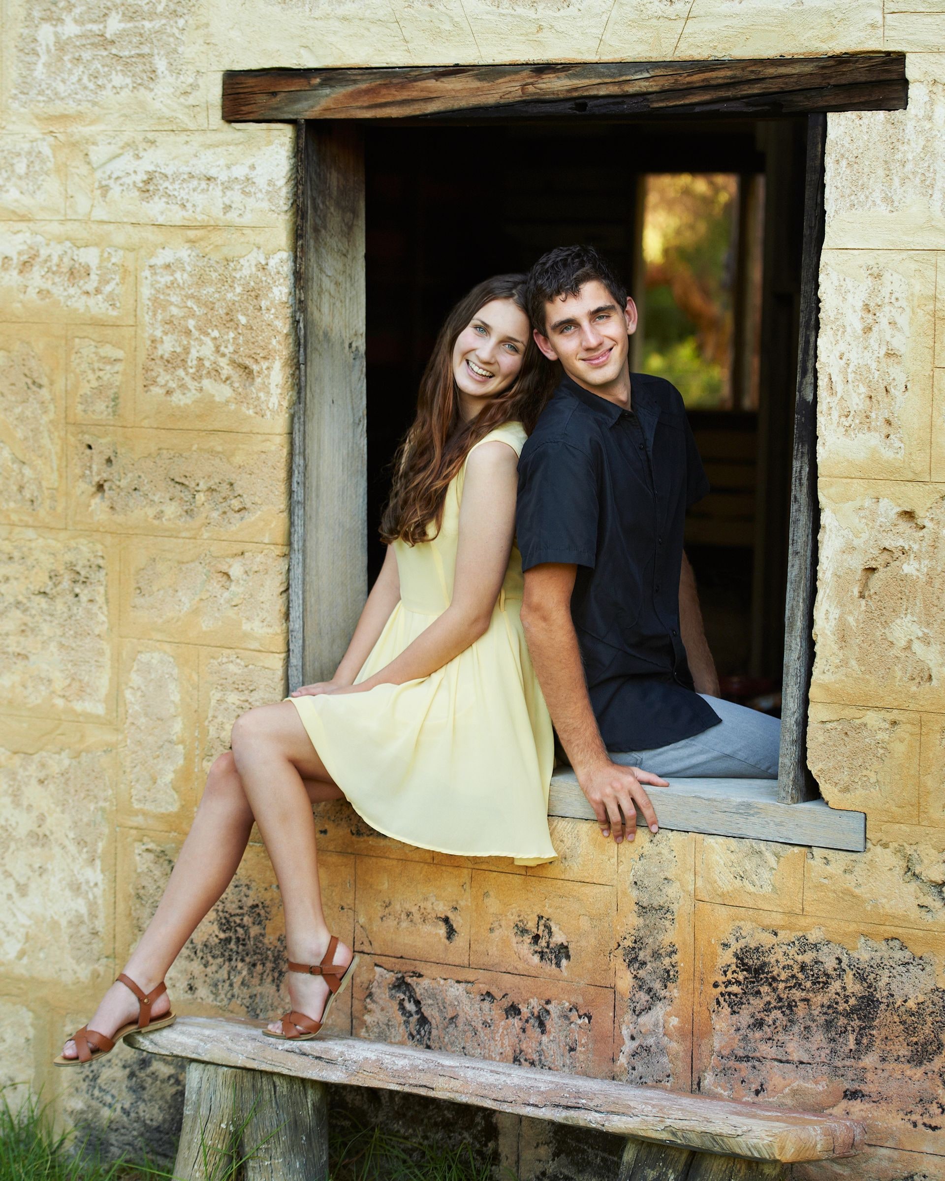 A young couple sitting in the limestone window