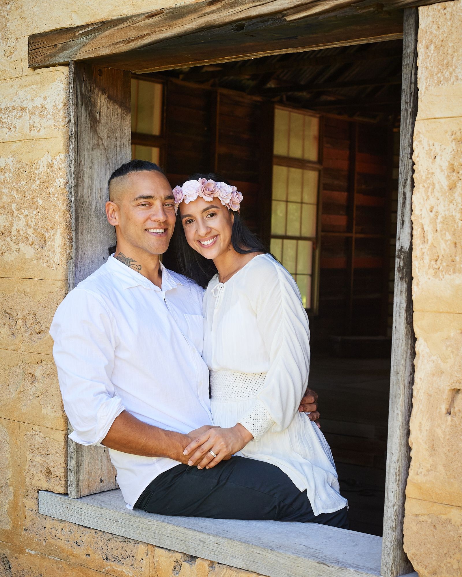 A couple sitting together in the limestone window