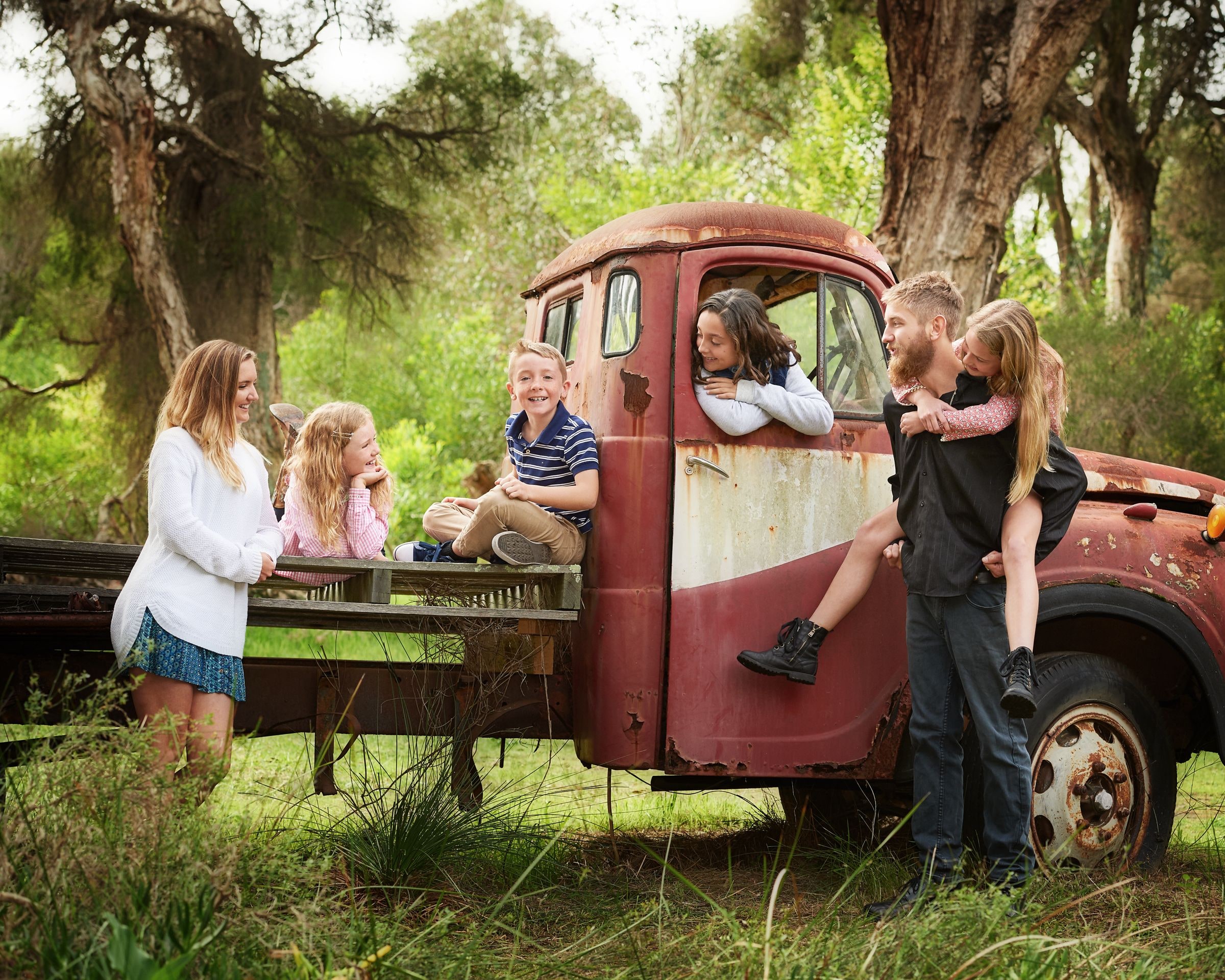 A family gathered around the tray of the red truck