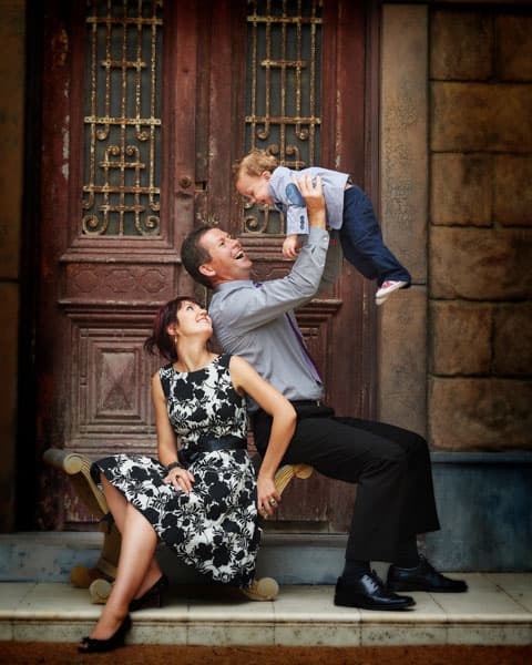 A father lifting his baby high at the Egyptian Doors while mum looks on