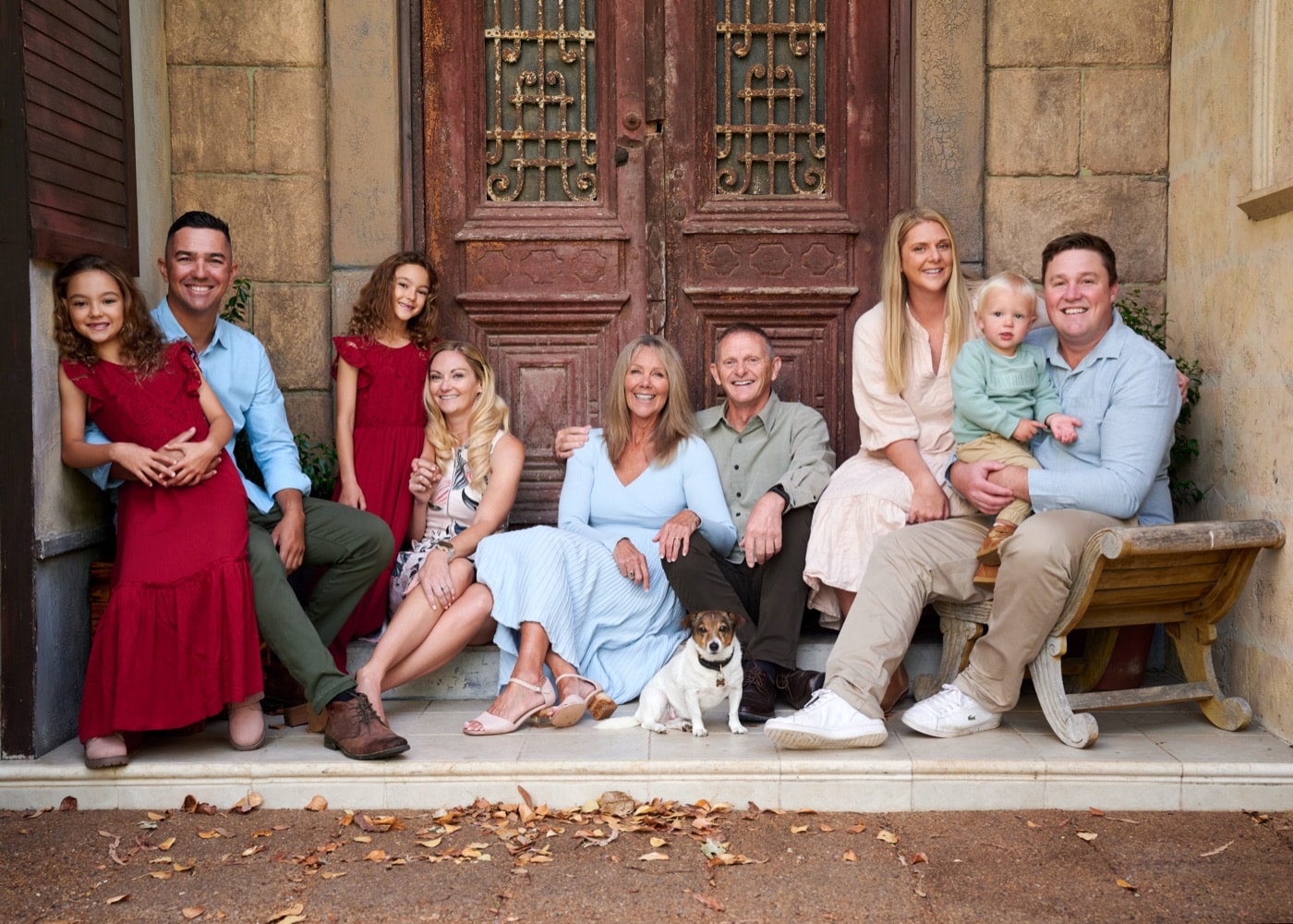 An extended family of ten and their dog by the Egyptian doors