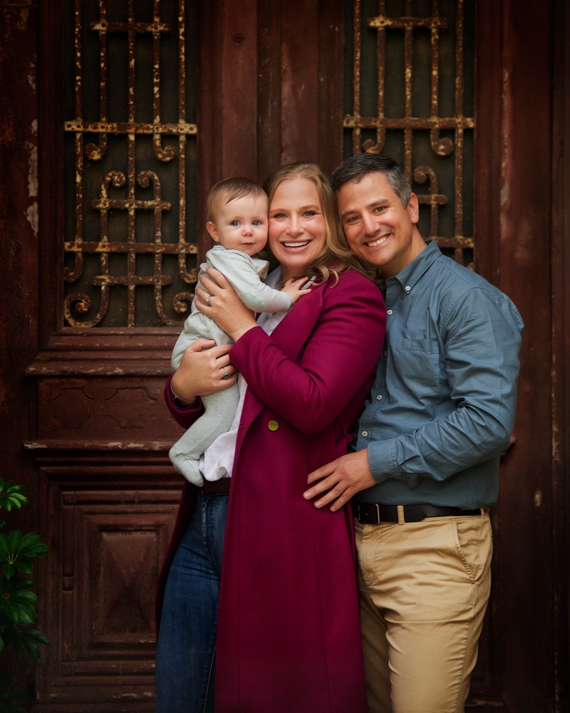 A couple holding their baby at the Egyptian doors