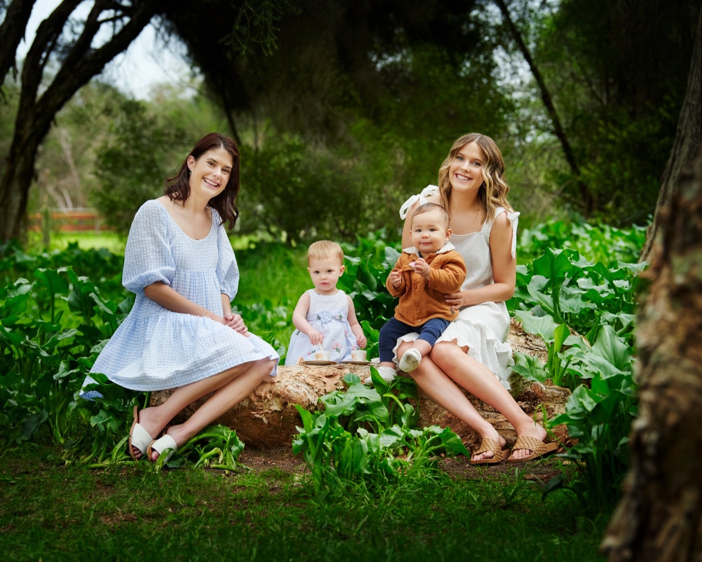 Two mothers with their children among the arum lilies