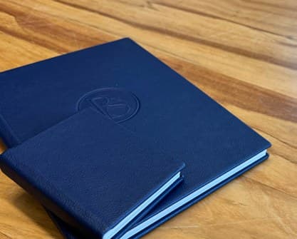 A mini parent album resting on a full-size designer album