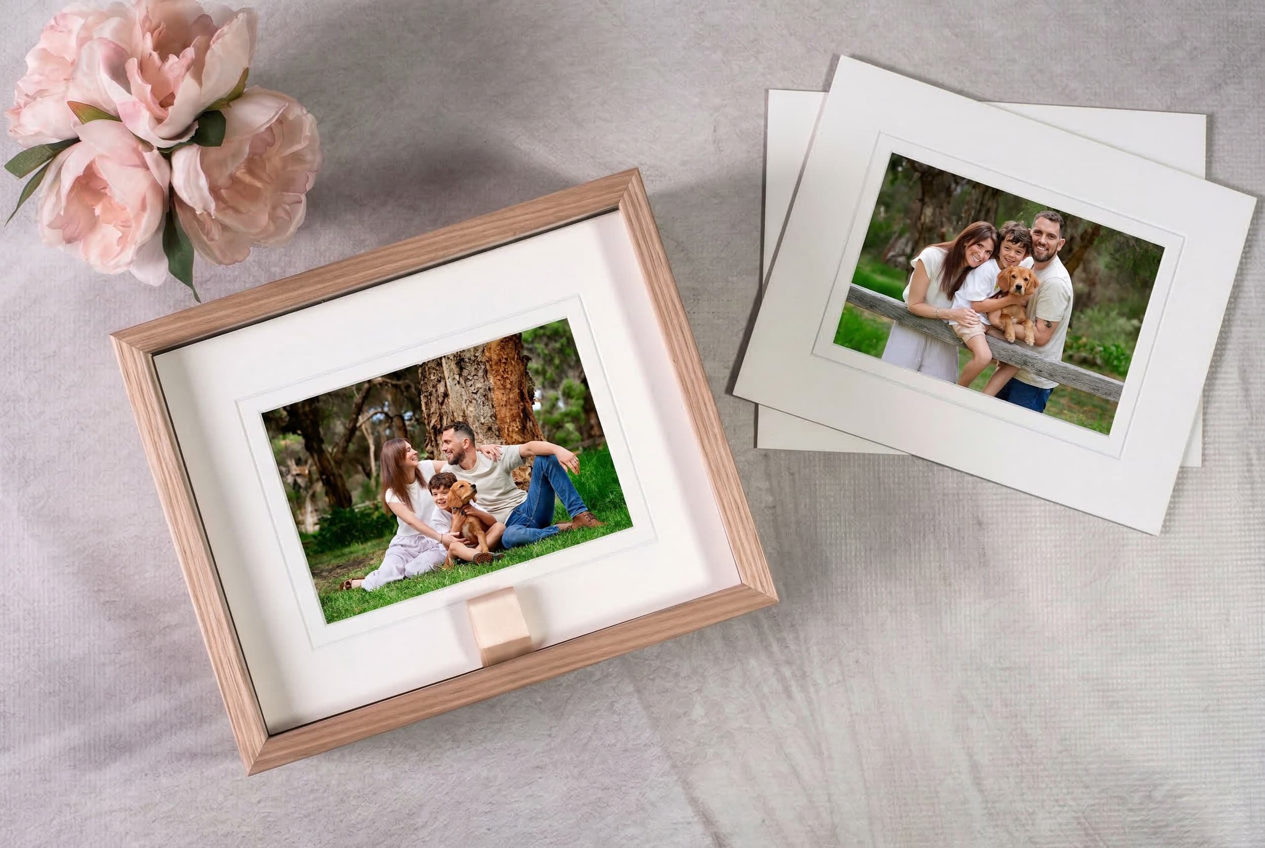 A Premier Studio portfolio box beside a matted print displayed on an acrylic stand